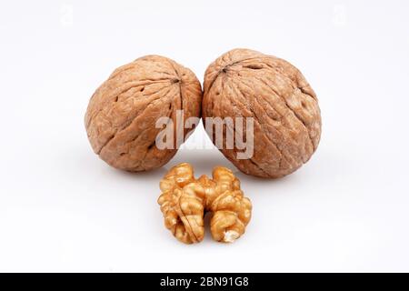 Two walnuts and walnuts with organic shell on a white background Stock Photo