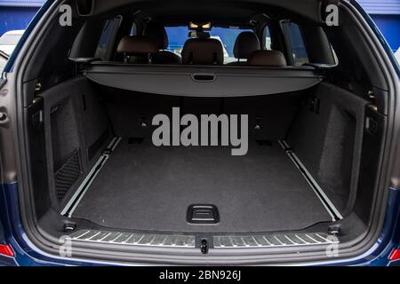 Family car empty car boot with luggage space available. Empty car boot car trunk with boot lid open on a family car, Rear view of a car with an open Stock Photo