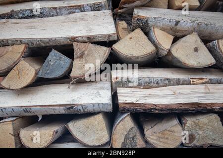 chopped firewood for the fireplace is neatly folded piles. Harvesting wood for the heating season. close-up, soft focus Stock Photo