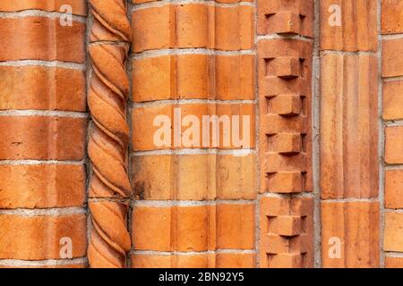 Brick work wall with ornament on old building. Red brick wall texture architecture background. Pattern of weathered antique brickwall. Stacked stones Stock Photo