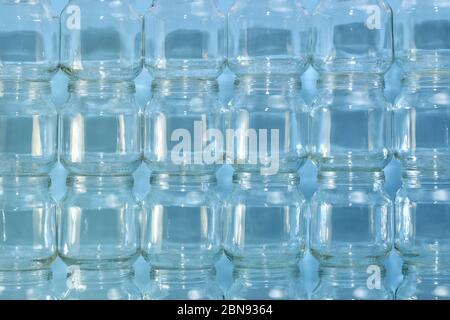The background is from the built wall of transparent small cans, horizontal enlarged fragment in the center. Stock Photo