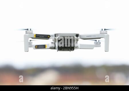 Mariefred, Sweden - May 2, 2020: Frontal view of a Dji Mavic Mini quadcopter drone hovering in an urban area. Stock Photo