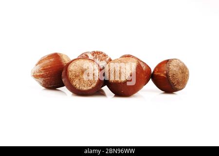 Organic and fresh hazelnuts together on white background Stock Photo