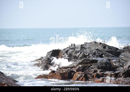 Sea waves hitting the rocks.Anjuna beach,Goa,India. Stock Photo