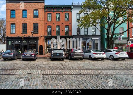 Thames St, Baltimore, Maryland, USA -- April 13, 2019. Wide angle photo of shops on Thames Street in the popular Fells Point Section of Baltimore. Stock Photo