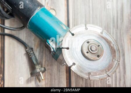 Old circular saw laying on the wooden background. Flat lay view of the electric tool Stock Photo