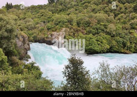 Stunning Huka Falls of Waikato River in Taupo District in Waikato Region on the North Island in New Zealand. The massive, powerfull waterfall is surro