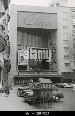 Vintage photograph, Plaza movie theater in Montevideo, Uruguay on July 5, 1955. With poster and marquee for Ingmar Bergman’s A Lesson in Love (Una lección de amor). Taken by a passenger debarked from a cruise ship. SOURCE: ORIGINAL PHOTOGRAPH Stock Photo