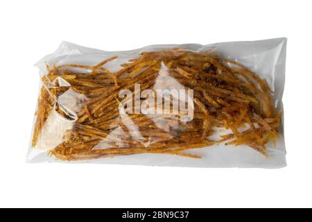 Dried salmon cobweb with pepper in a transparent package appetizer to beer isolated on white background. Snack Fish to beer. Close up Stock Photo