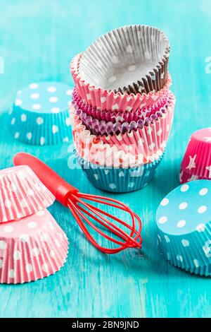 Variation of small paper forms for baking cupcakes and muffins with wisp. Colorful paper liners. Stock Photo