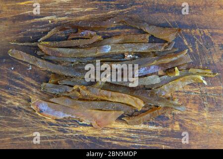 Dried carp fish sticks on wooden background. Snack Fish to beer. Close up Stock Photo