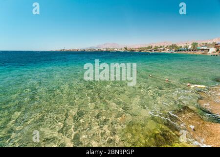 Red Sea Dahab blue water with mountainy in the background Stock Photo