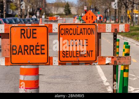Montreal, Canada - 13 May 2020: Construction site on Mentana Street. Signs meaning "Rue Barree" & Local traffic only in french Stock Photo