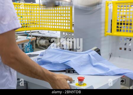 Automatic Ironing Machines For Knitwear and shirt  with Press in the textile factory. Stock Photo