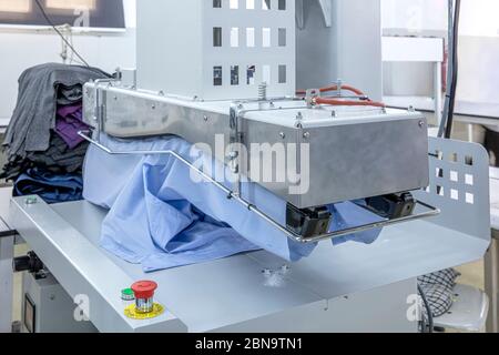 Automatic Ironing Machines For Knitwear and shirt  with Press in the textile factory. Stock Photo