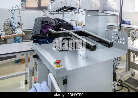 Automatic Ironing Machines For Knitwear and shirt  with Press in the textile factory. Stock Photo