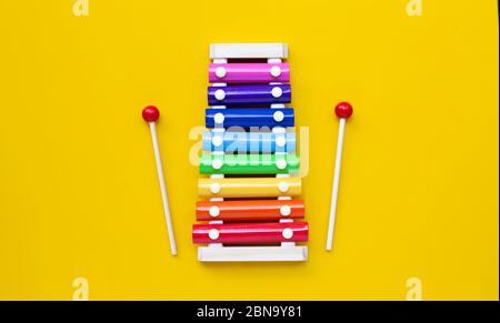 Colorful xylophone on yellow background. Copy space Stock Photo