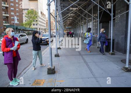 New York, New York, USA. 13th May, 2020. Residents pay homage to health professionals at Mount Sinal Hospital on Manhattan Island in New York City, USA. New York City is the epicenter of the Coronavirus pandemic Credit: William Volcov/ZUMA Wire/Alamy Live News