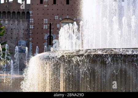 Fountain In front of the entrance to castle known as Castello Sforzesco, Milan, Lombardy, Italy. Closeup view Stock Photo