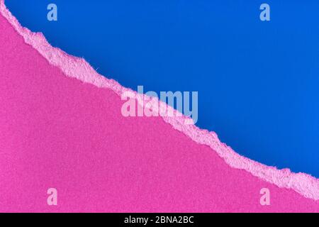 Torn purple paper edge on blue background. Ripped paper piece edge isolated with soft shadow. Copy space, frame, banner Stock Photo