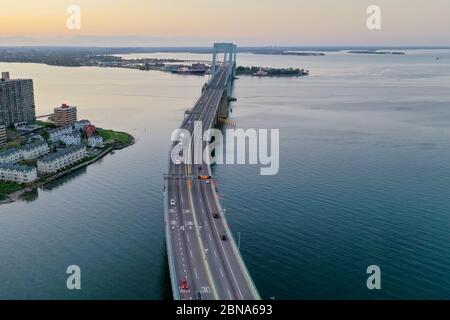 Aerial view of the Throgs Neck Bridge connecting the Bronx with Queens in New York City at sunset. Stock Photo