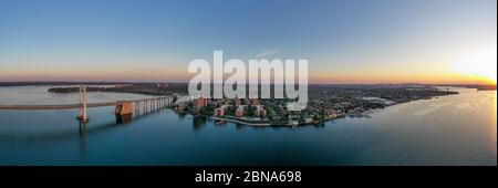 Aerial view of the Throgs Neck Bridge connecting the Bronx with Queens in New York City at sunset. Stock Photo