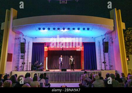 Miami Beach Florida,North Beach Band Shell audience,night night nightlife evening after dark,free opera performance duo,stage,singer performer perform Stock Photo