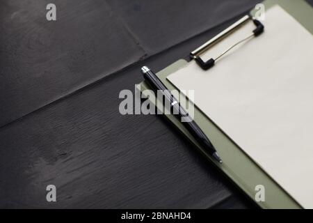 Close-up of blank paper on the clipboard with pen on the wooden table Stock Photo