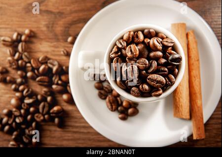 Coffee cup with cinnamon sticks and beans view from above Stock Photo