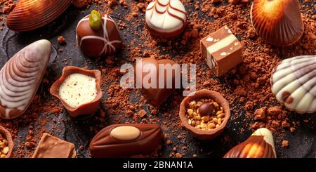 Belgian chocolate assortment panorama, various bonbons on a dark background Stock Photo