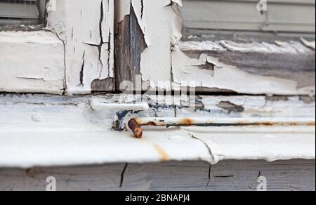 windowsill where the color is flaking and the wood cracked Stock Photo