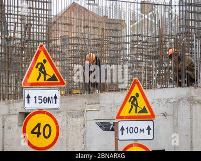 Construction workers collaborating in the installation  fittings at a construction site. Stock Photo