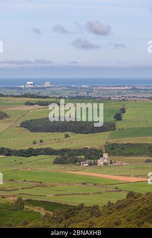 View to Heysham nuclear power stations from Clough, with saint Peter church, Quernmore valley,  Lancashire, UK Stock Photo