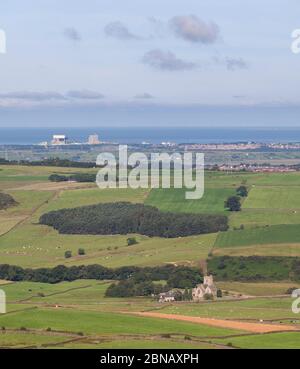 View to Heysham nuclear power stations from Clough, with saint Peter church, Quernmore valley,  Lancashire, UK Stock Photo