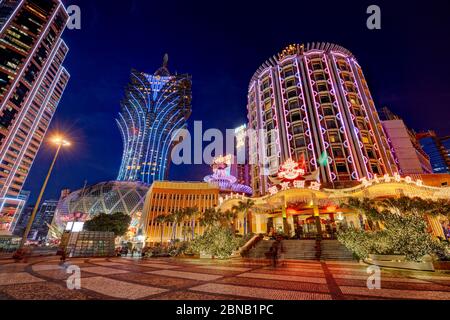 Hotels Lisboa and Grand Lisboa illuminated at night. Macau, China. Stock Photo