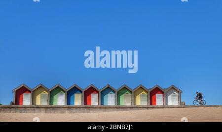 A clear blue sky over beach huts in Blyth, Northumberland, as highs of 22C are now expected for some parts of the UK by the weekend. Stock Photo