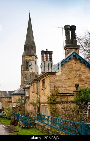 UK, England, Derbyshire, Edensor, Norman Villa, mid-victorian houses below St Peter’s Church spire in winter Stock Photo