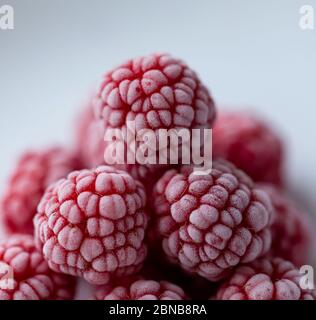 Fresh red raspberries on the white background Stock Photo