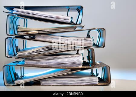 Stack of office folders with archived paperwork in red light Stock Photo