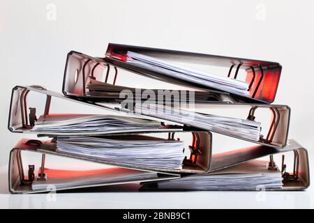 Heap of office folders with archived paperwork in red light Stock Photo