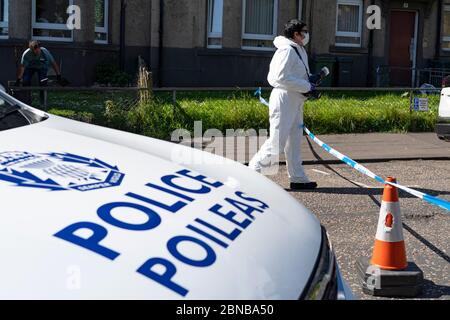 Edinburgh, Scotland, UK. 14 May 2020. Police and forensic team attend a crime scene at address in Restalrig area of Edinburgh following a serious assault at a property in Hawkhill Avenue in the east of the city. The  incident happened around 10.30pm on Wednesday, 13 May, 2020 and a 27-year-old man was taken to Edinburgh Royal Infirmary for treatment for his injuries.  Iain Masterton/Alamy Live News Stock Photo