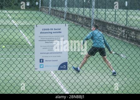 WIMBLEDON LONDON, 14 May 2020. UK.Tennis During Lockdown: People playing tennis outdoors at the Wimbledon Park tennis courts following government advice that lockdown rules have been relaxed for a number of sport including  golf and tennis while keeping social distancing of two metres apart . Credit: amer ghazzal/Alamy Live News Stock Photo