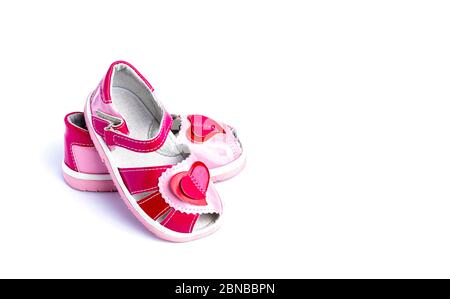 Children's shoes with a red heart. Isolated on white background. Stock Photo