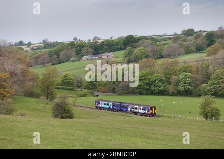 Northern Rail class 150 diesel sprinter train in the countryside passing Mewith on the 'little north western' railway line in west Yorkshire Stock Photo