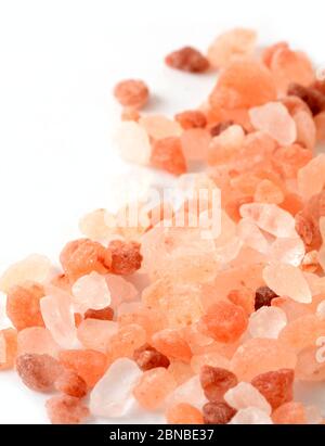 Macro of Pink Himalayan Rock Coarse Salt on White Background. Stock Photo