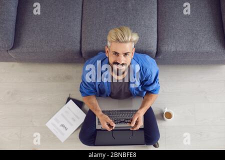 Education learning study online video call chat. Top view. Guy student hipster smiling is studying an online lesson training with a teacher using a la Stock Photo