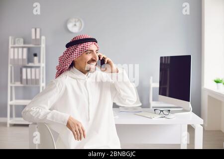 Arabian businessman talking on a cell phone in the office. Arab business people concept. Stock Photo