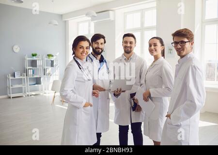 A team of doctors in a meeting discusses the diagnosis of a patient in a clinic office. Teamwork of doctors at the conference of colleagues in the hos Stock Photo