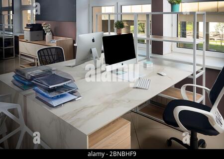 GRODNO, BELARUS - MAY 2020: Two Apple Imac in office table with