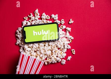 LONDON, UK - MAY 14 2020: Hulu logo on a smartphone with popcorn Stock Photo